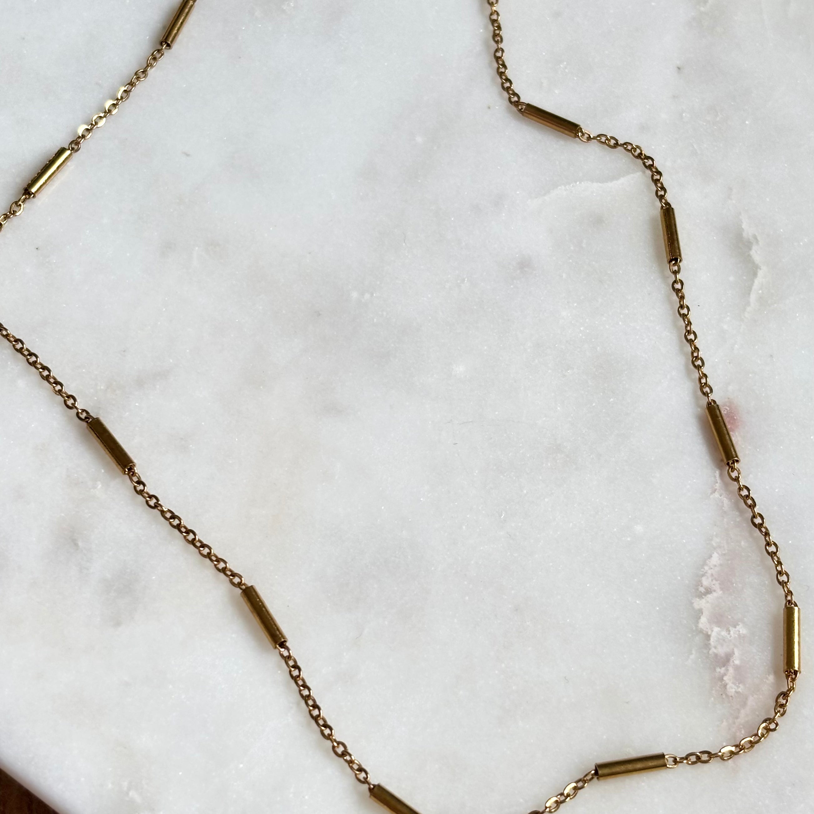 Gold Bar Chain Necklace with 18K gold plated stainless steel chain on marble background