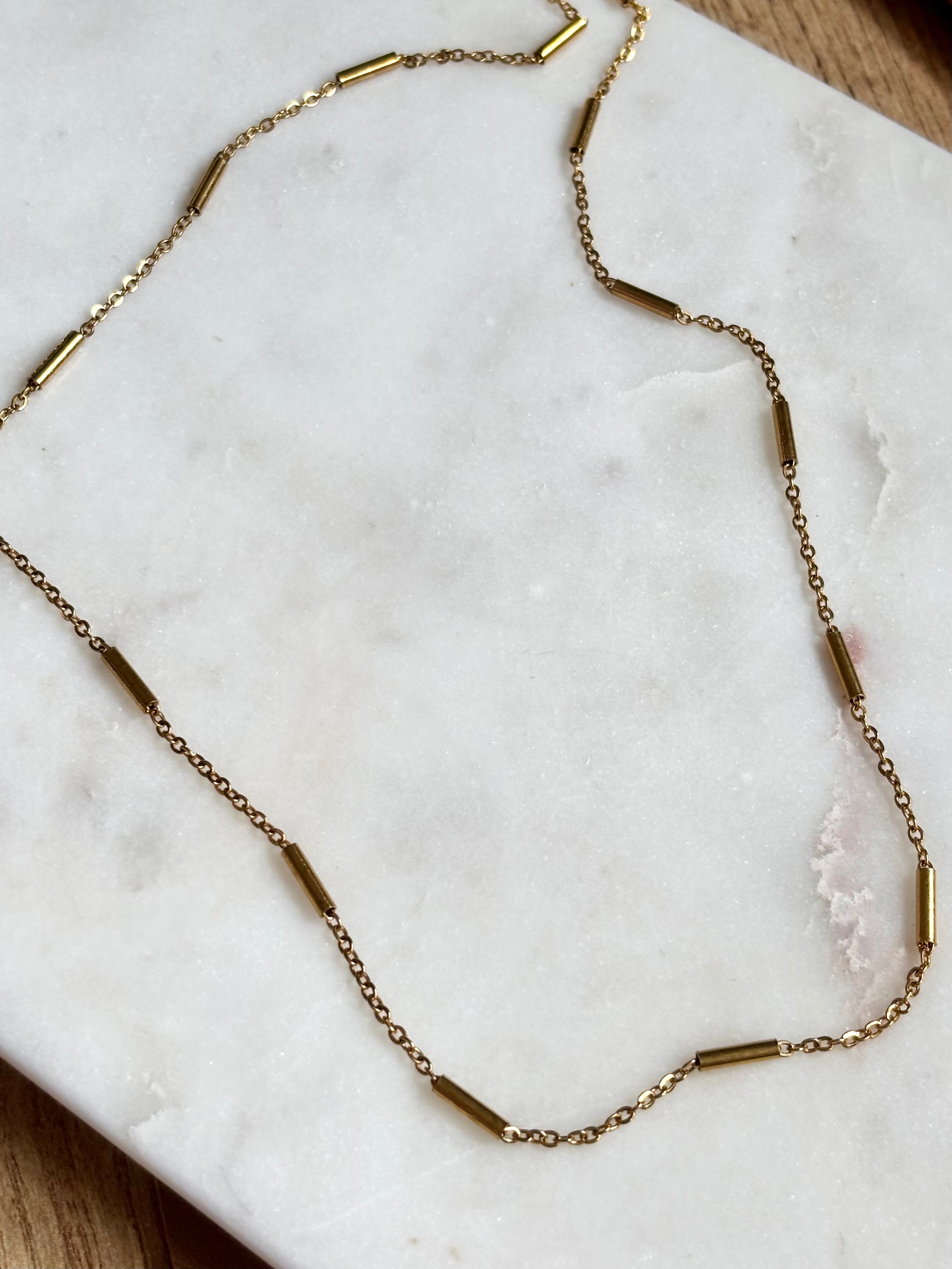 Gold Bar Chain Necklace with 18K gold plated stainless steel chain on marble background