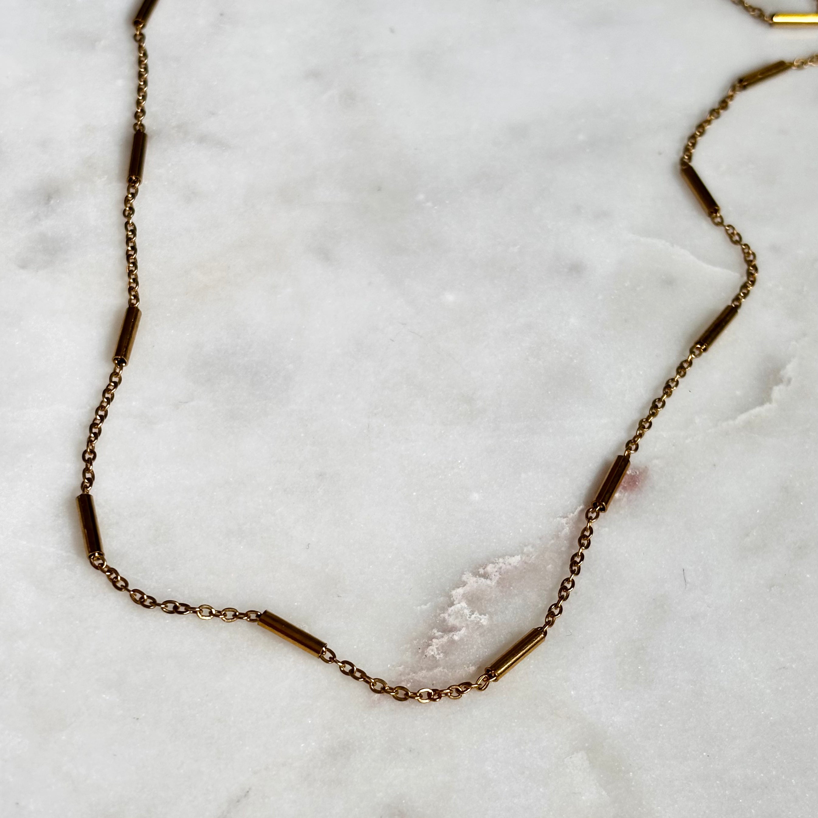 Gold Bar Chain Necklace with 18K gold plated stainless steel chain on marble background